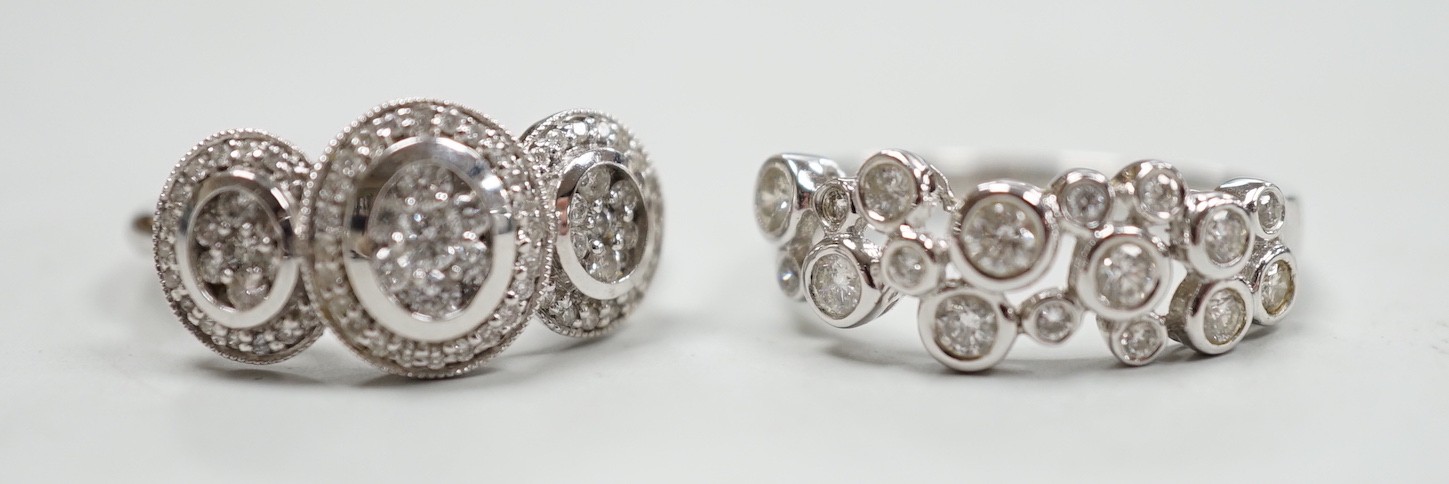 A modern 18ct white gold and diamond set triple cluster ring, size M and a similar 18ct white gold and collet set diamond cluster ring, size N, gross weight 7.5 grams.